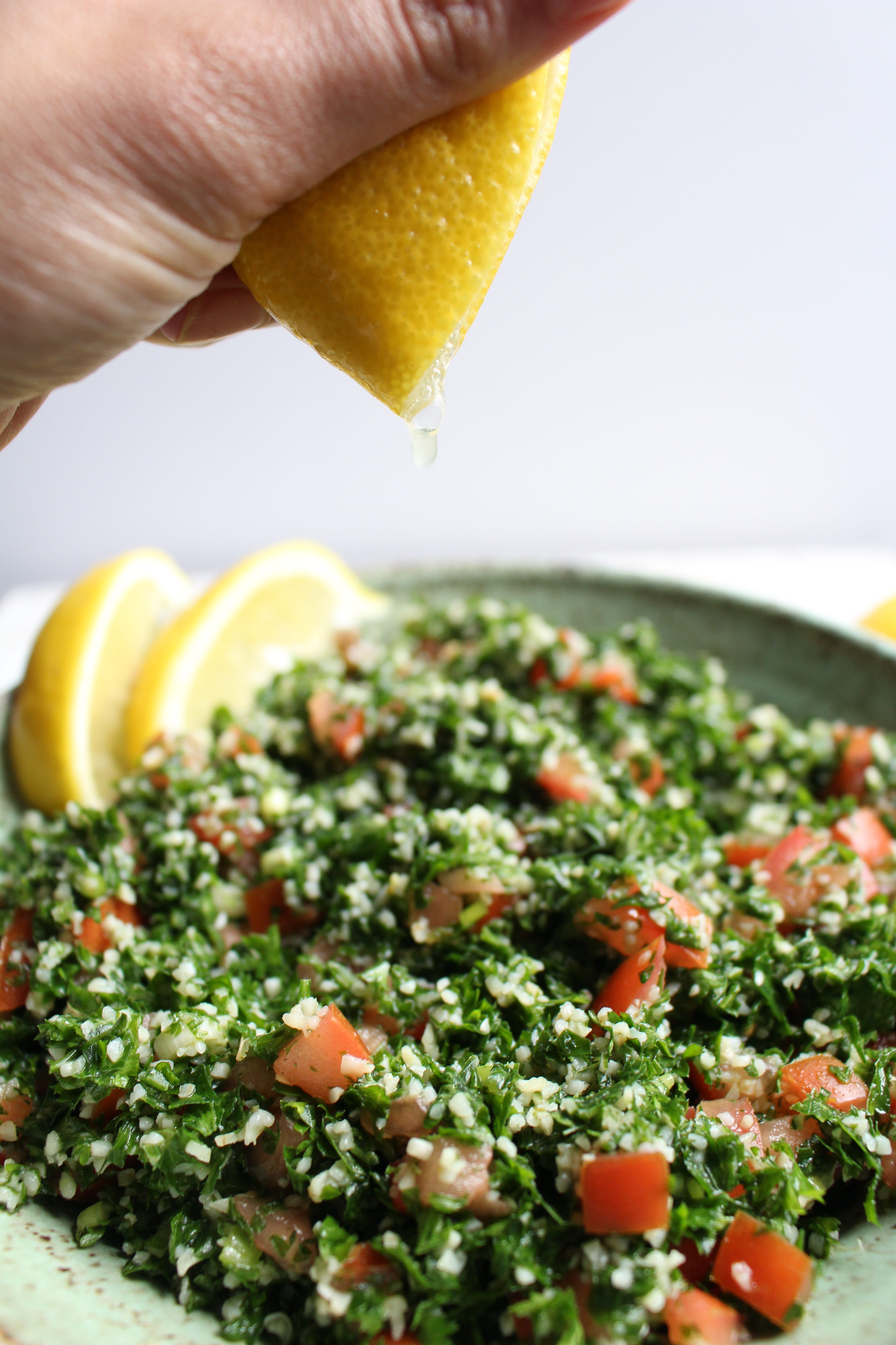Tabbouleh - a refreshing and healthy Middle Eastern salad made with parsley, tomatoes, and bulgur. Dressed with lemon juice, olive oil, and mint, this salad is great by itself, in lettuce cups, or with avocado! 
