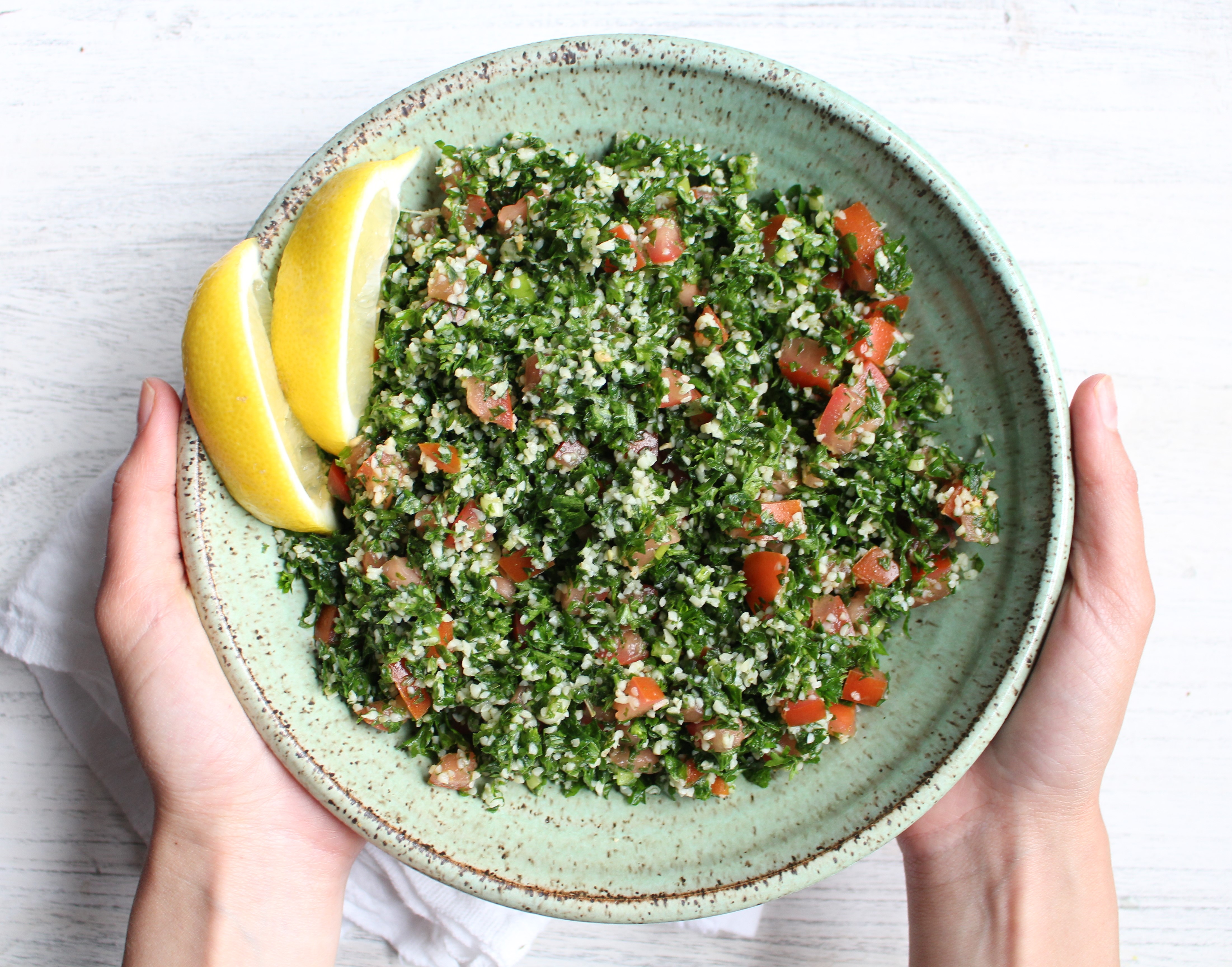 Tabbouleh - a refreshing and healthy Middle Eastern salad made with parsley, tomatoes, and bulgur. Dressed with lemon juice, olive oil, and mint, this salad is great by itself, in lettuce cups, or with avocado! 