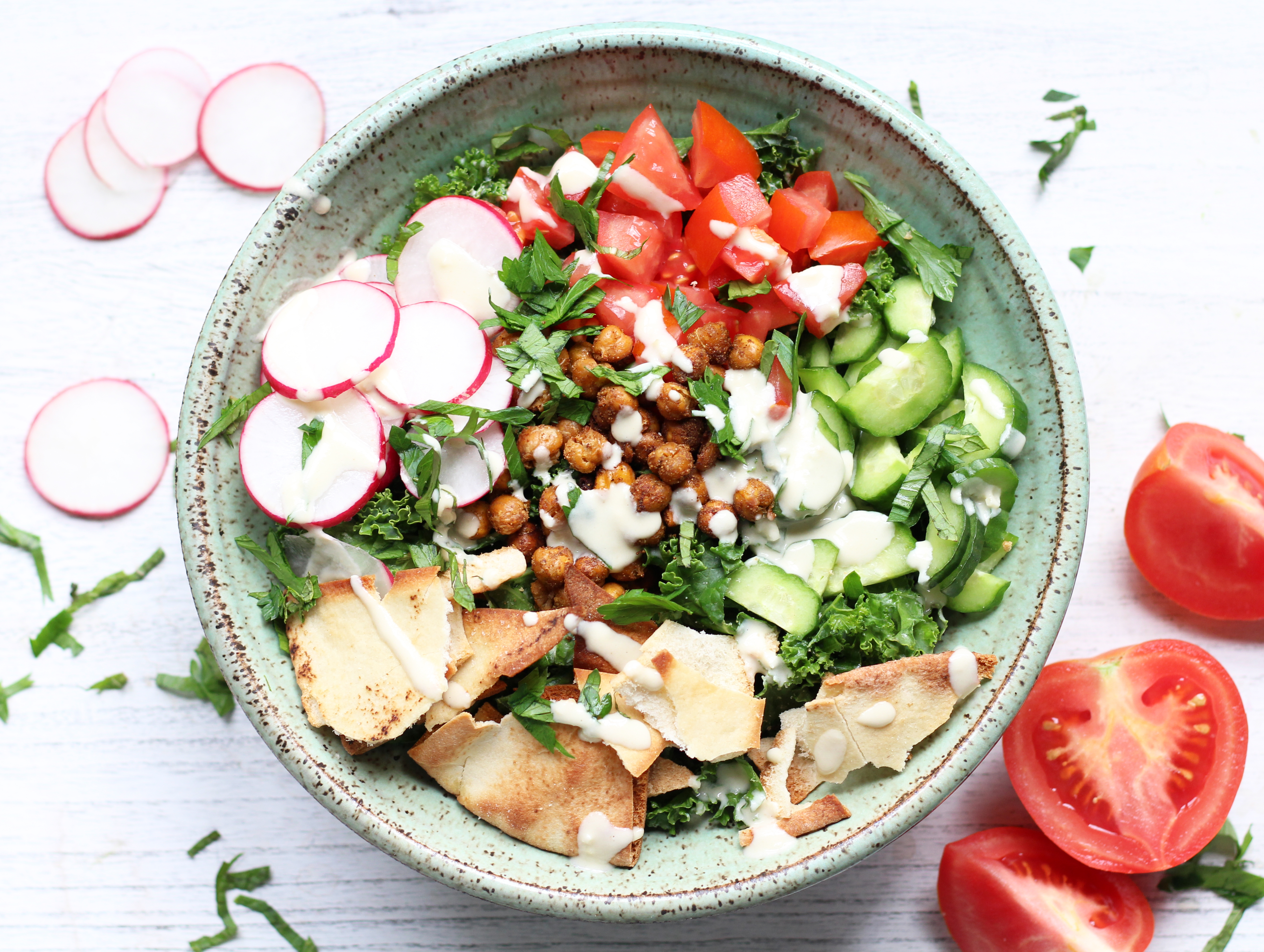 Falafel-inspired kale salad with crispy roasted chickpeas, fresh vegetables, and all the familiar spices of a traditional falafel wrap.