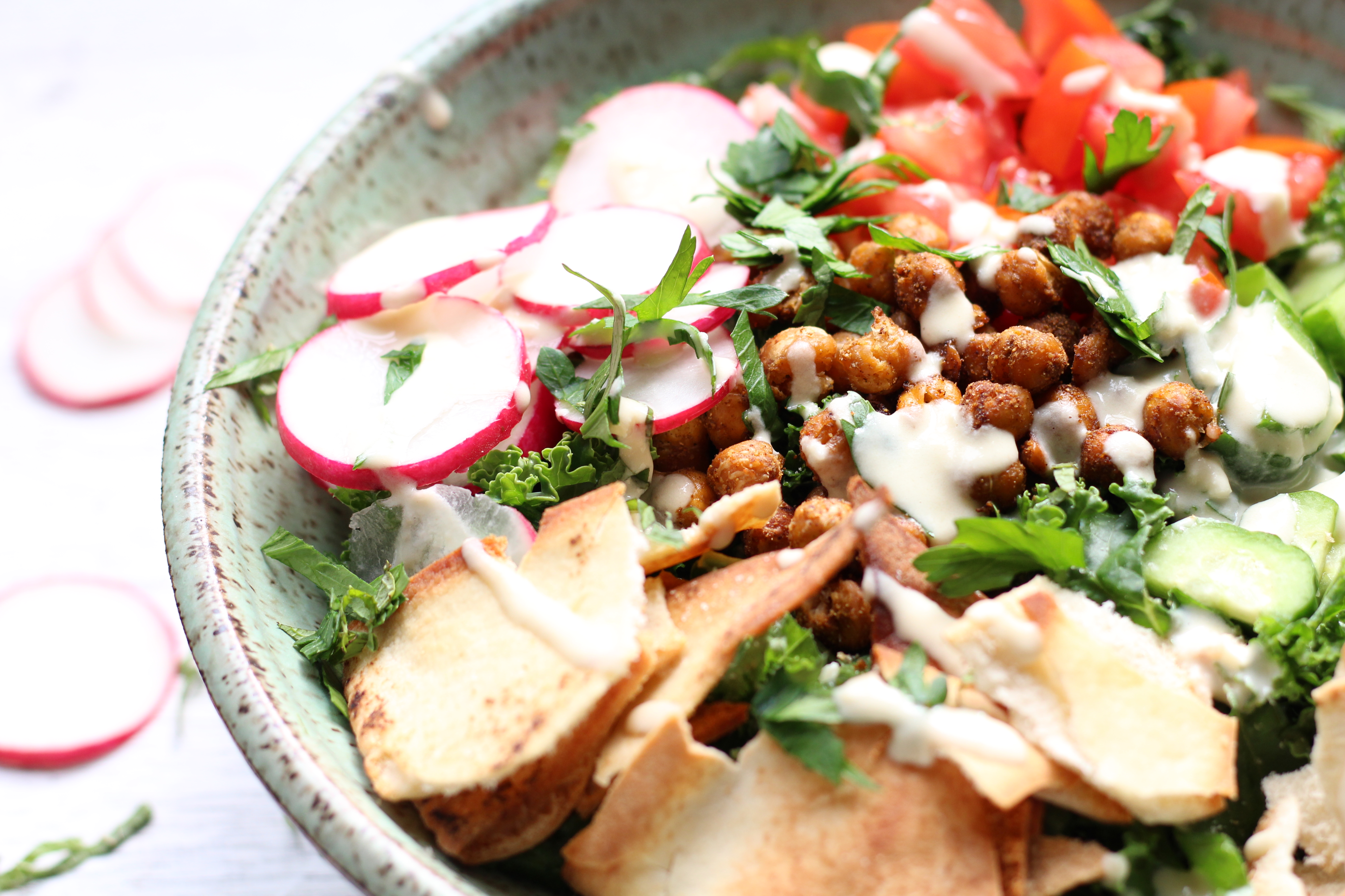 Falafel-inspired kale salad with crispy roasted chickpeas, fresh vegetables, and all the familiar spices of a traditional falafel wrap.