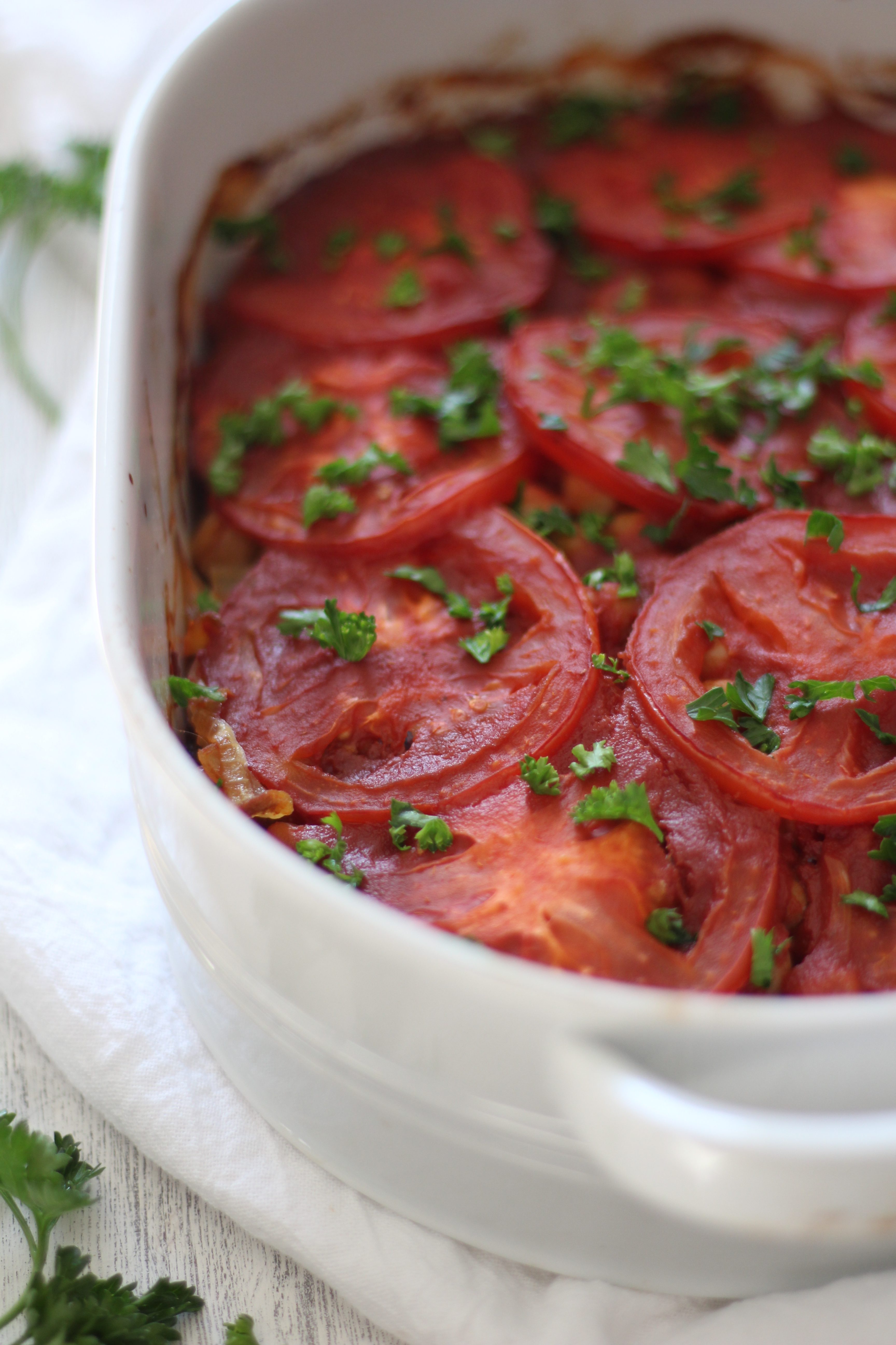 A comforting and healthy Mediterranean casserole with layers of eggplant, caramelized onions, chickpeas, and tomatoes - and simple to prepare!