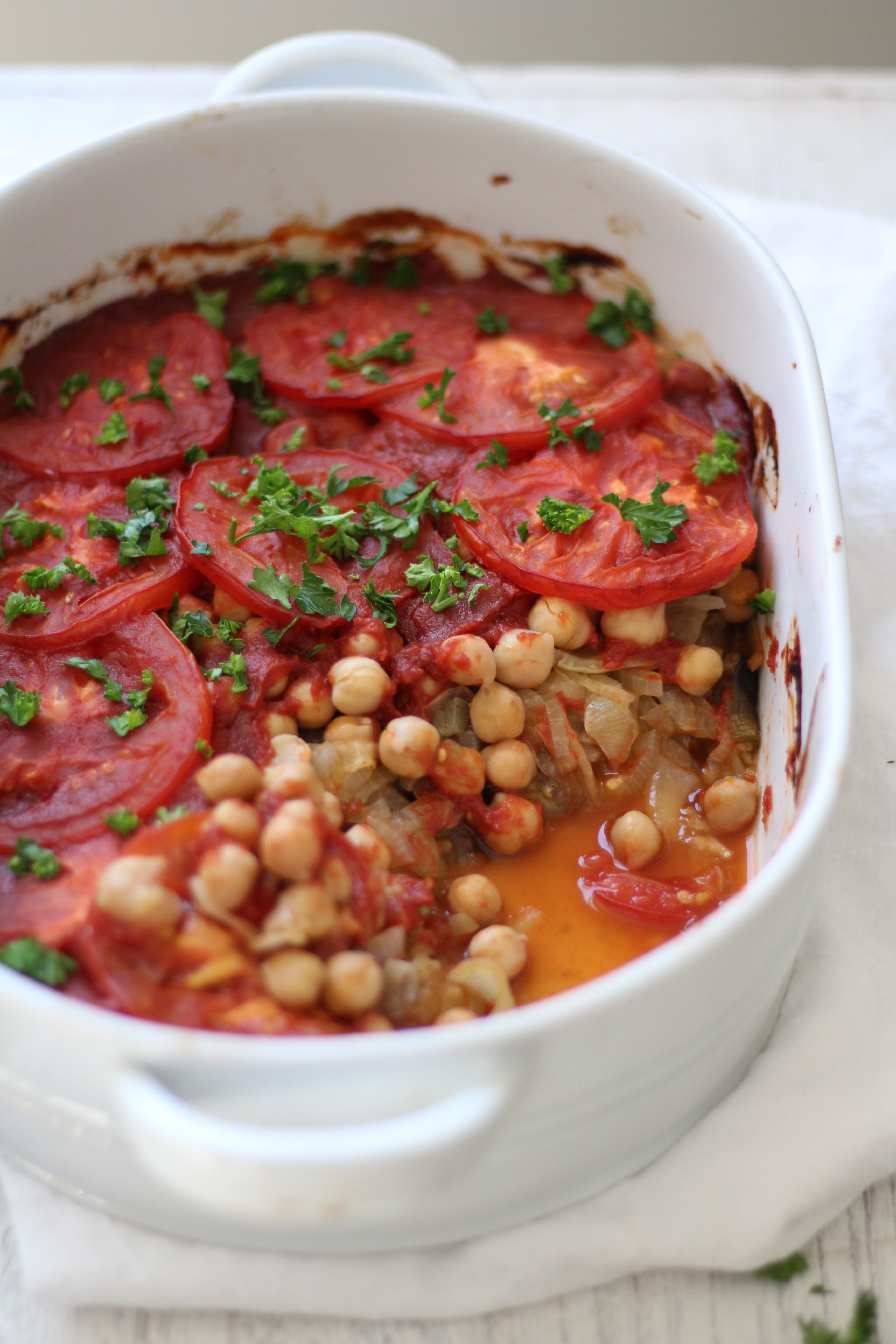 A comforting and healthy Mediterranean casserole with layers of eggplant, caramelized onions, chickpeas, and tomatoes - and simple to prepare!