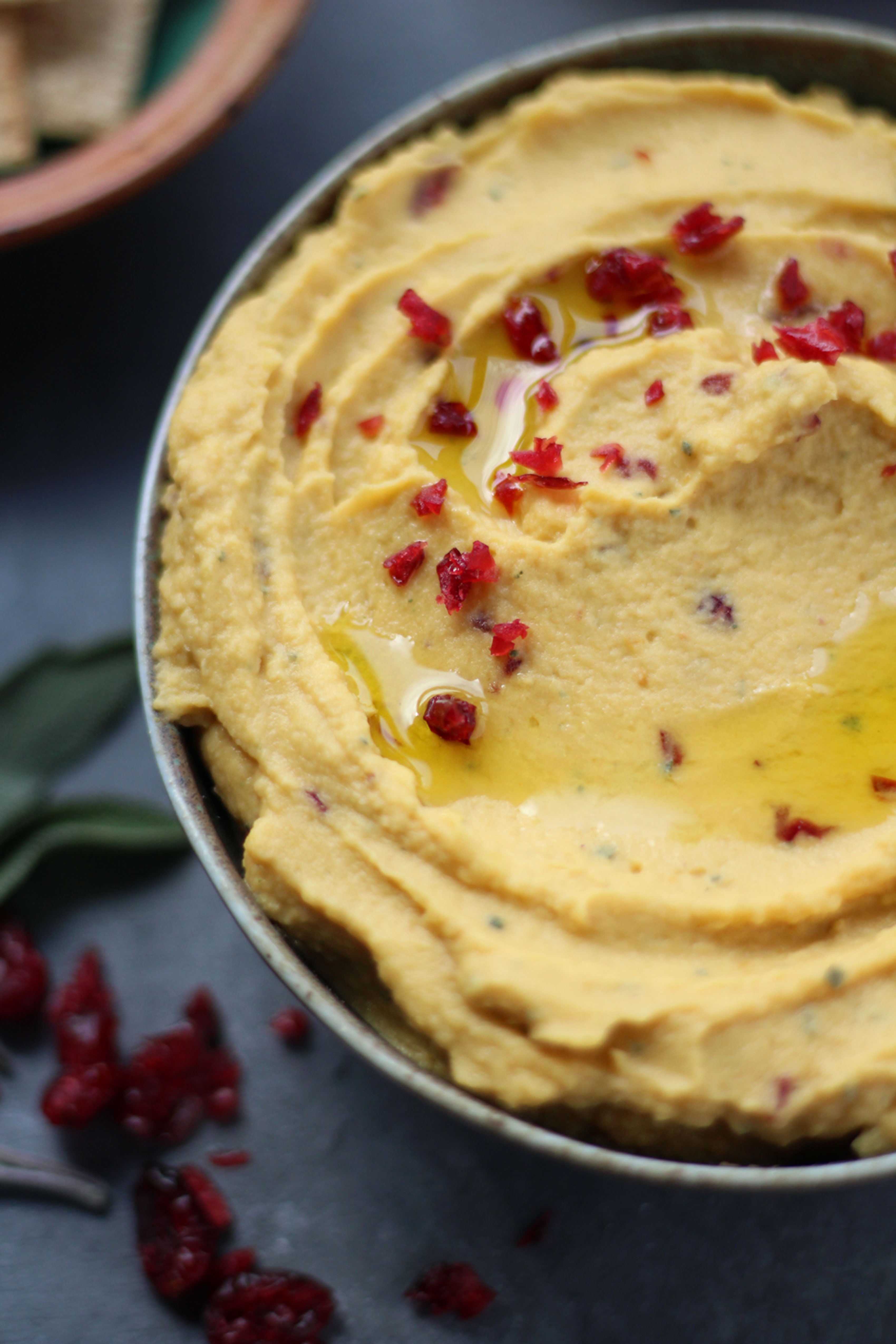 Roasted Garlic and Sage Pumpkin Hummus - a sweet and savory hummus packed with fall and Thanksgiving flavors. Perfect on warm pita, pita chips, crackers, and more! 
