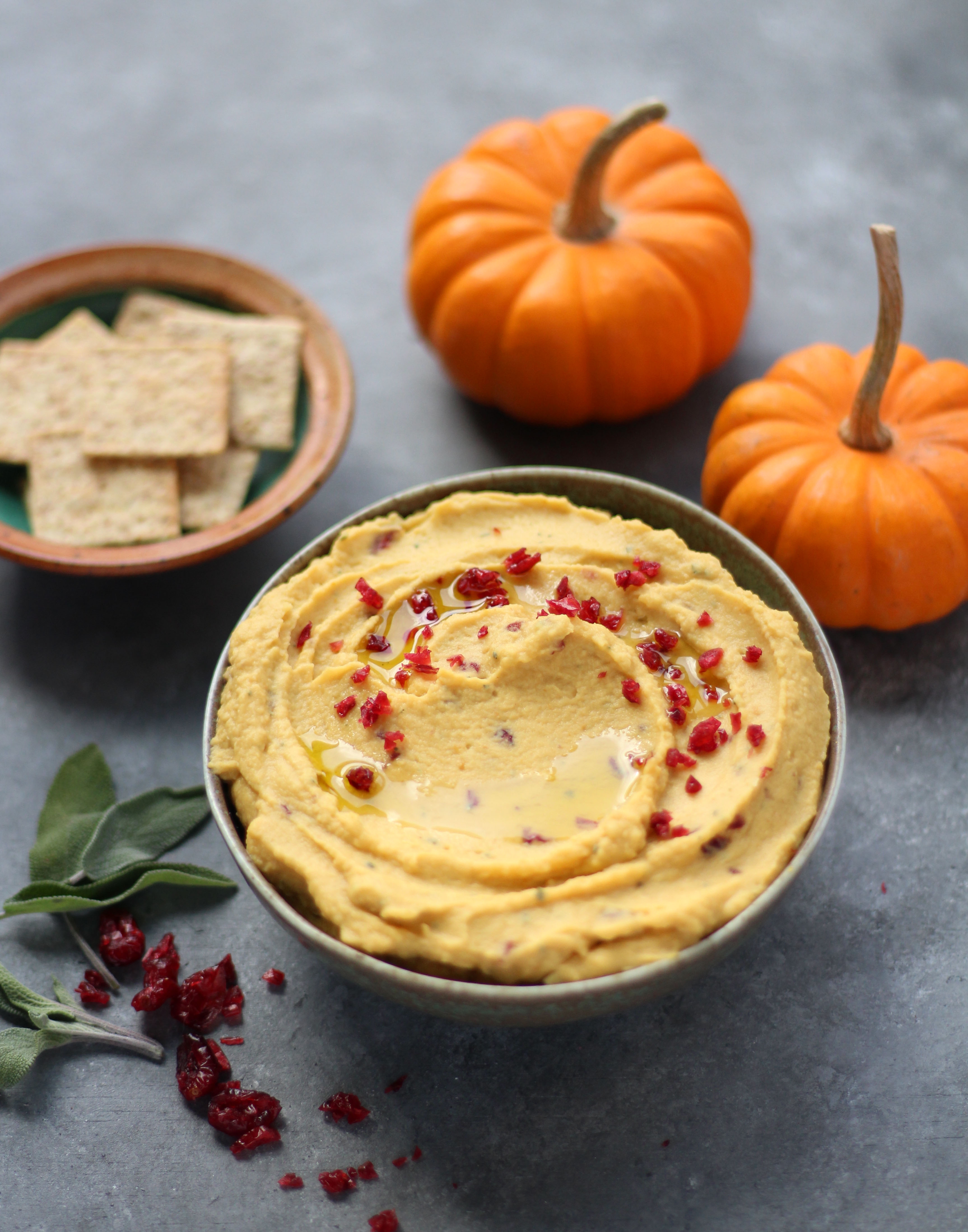 Roasted Garlic and Sage Pumpkin Hummus - a sweet and savory hummus packed with fall and Thanksgiving flavors. Perfect on warm pita, pita chips, crackers, and more! 