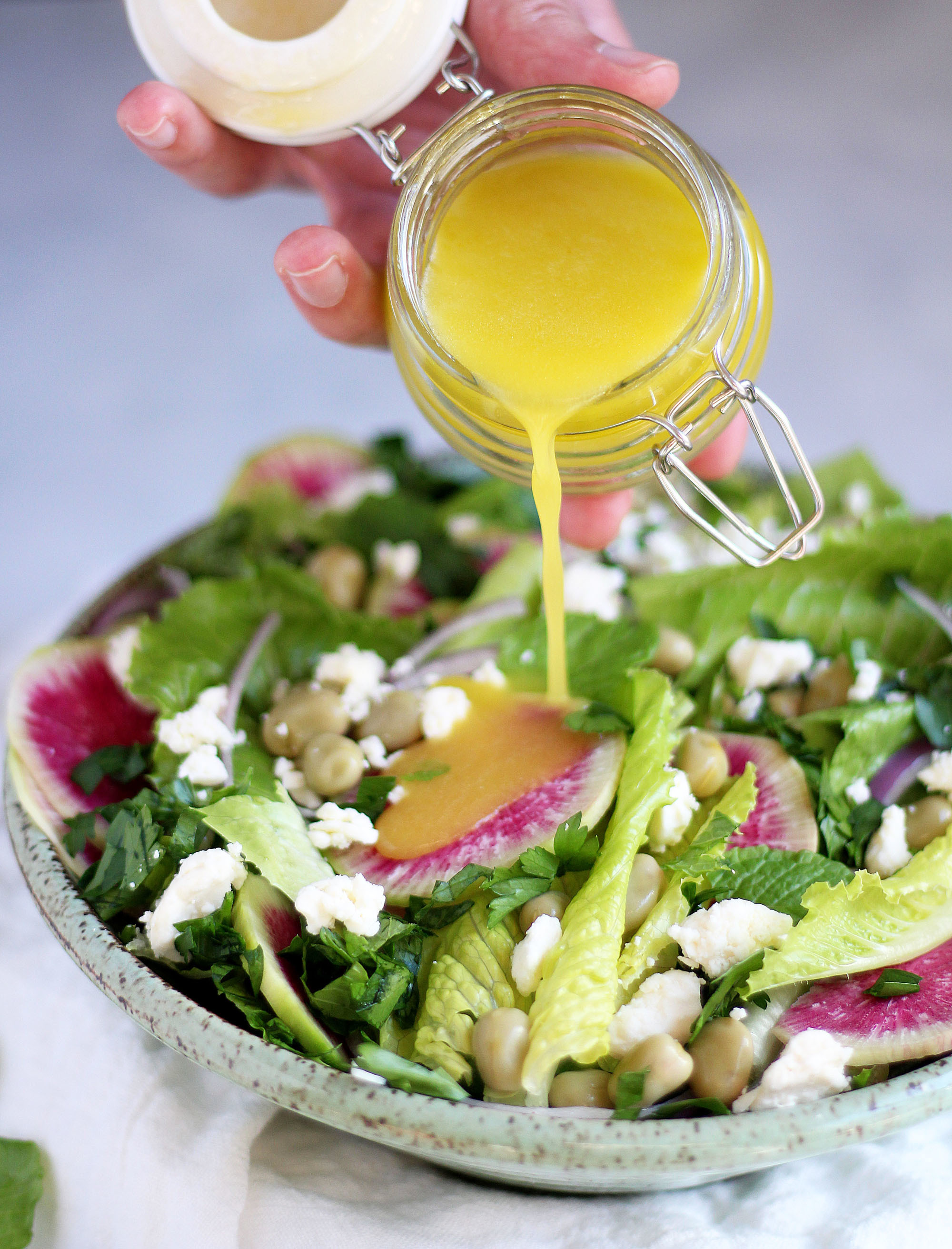 Crunchy romaine salad with fava beans, watermelon radishes, feta, and herbs. 