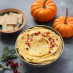 Roasted Garlic and Sage Pumpkin Hummus - a sweet and savory hummus packed with fall and Thanksgiving flavors. Perfect on warm pita, pita chips, crackers, and more!